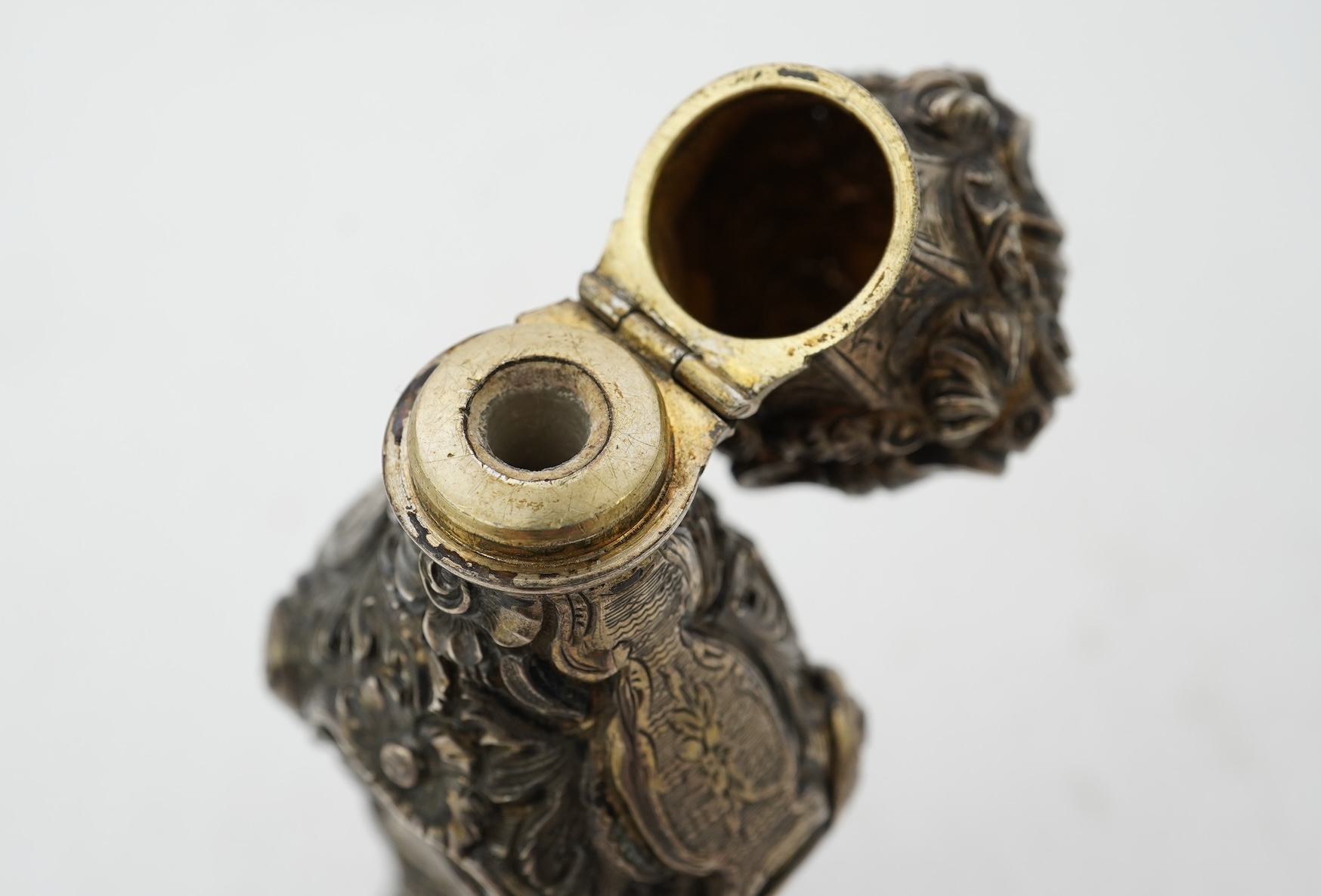 A 19th century French ornate parcel gilt white metal scent flask, with hinged cover and glass stopper